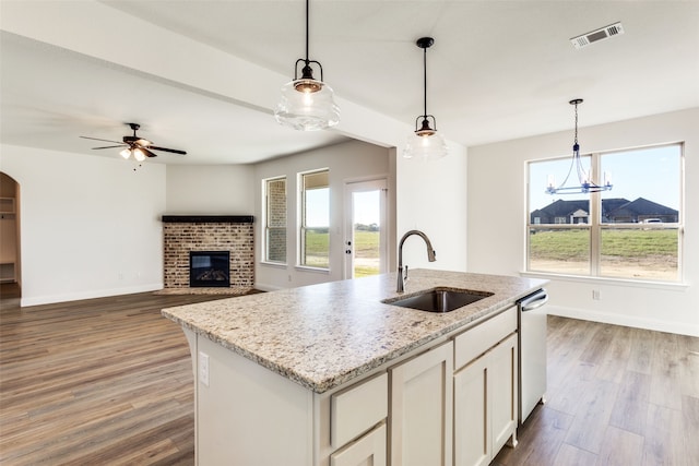 kitchen featuring hardwood / wood-style floors, hanging light fixtures, plenty of natural light, and sink