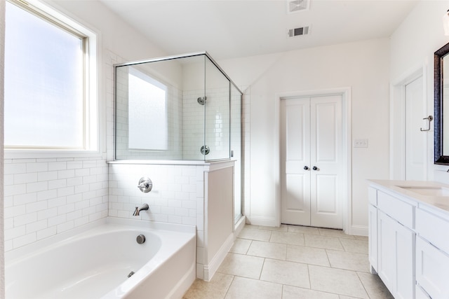 bathroom featuring vanity, separate shower and tub, and tile patterned floors