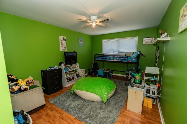 bedroom with ceiling fan and hardwood / wood-style flooring