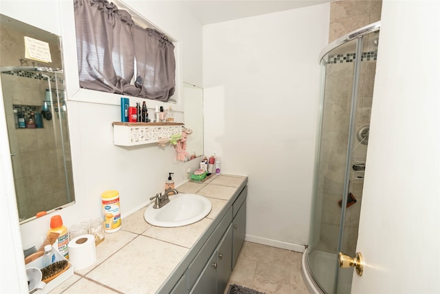 bathroom featuring a shower with door and vanity