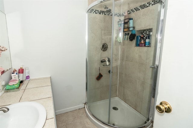 bathroom featuring walk in shower, tile patterned floors, and sink