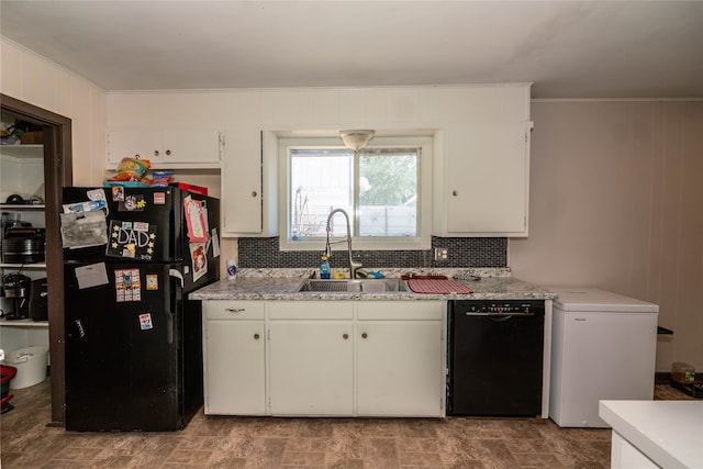 kitchen with decorative backsplash, white cabinets, black appliances, and sink