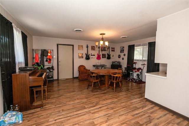 dining room with a notable chandelier and hardwood / wood-style floors