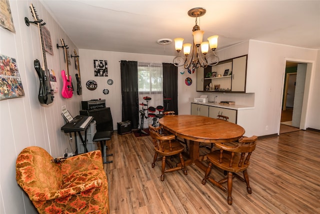 dining area featuring a notable chandelier and hardwood / wood-style floors