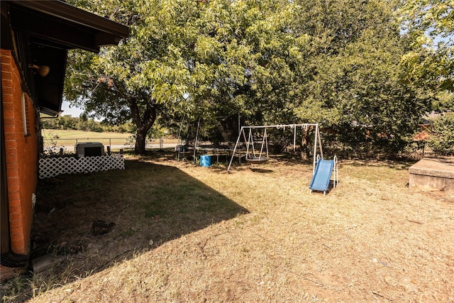 view of playground with a lawn