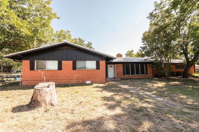 rear view of property with a yard