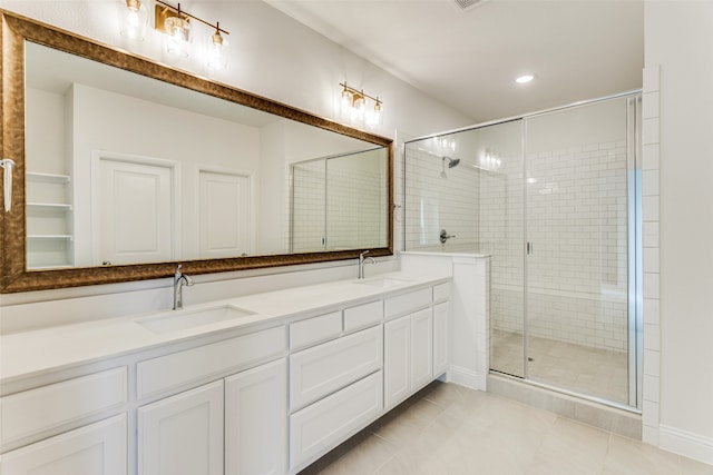 bathroom with double vanity, recessed lighting, a sink, and a shower stall