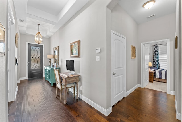 entrance foyer featuring dark hardwood / wood-style flooring and a notable chandelier