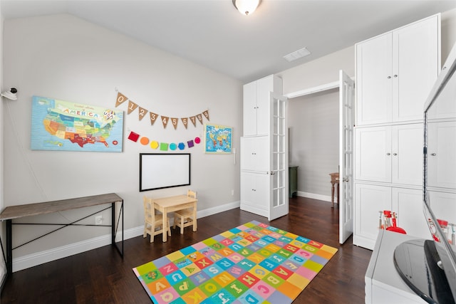 rec room with vaulted ceiling and dark hardwood / wood-style flooring