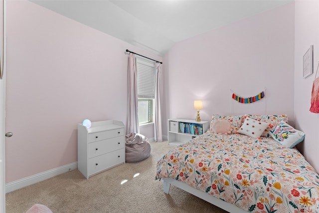 bedroom with vaulted ceiling and carpet floors