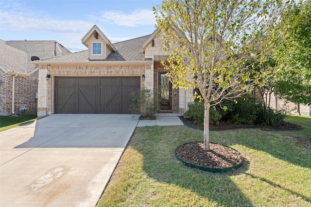 view of front of home with a garage and a front lawn