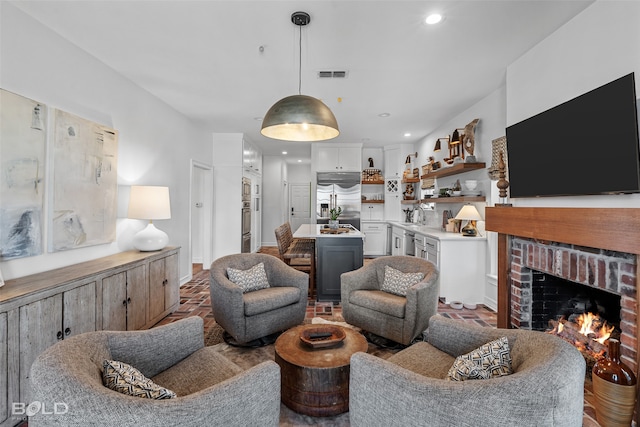 living room featuring a fireplace and sink