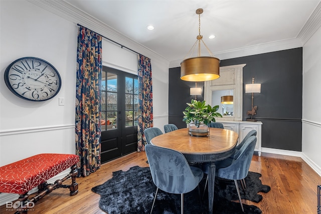 dining room with light hardwood / wood-style flooring and ornamental molding