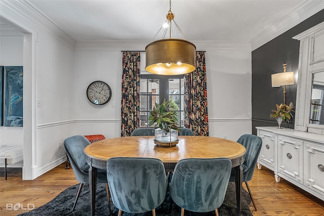 dining area with crown molding and light wood-type flooring