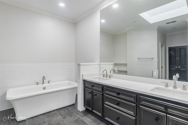 bathroom featuring ornamental molding, tile walls, a tub to relax in, and vanity