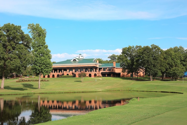 view of property's community featuring a lawn and a water view