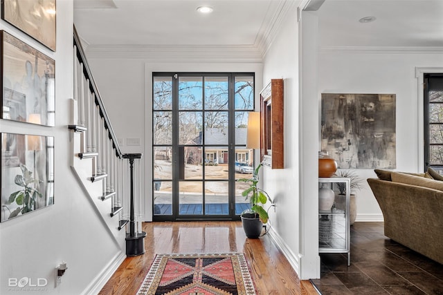 entryway featuring wood-type flooring and ornamental molding