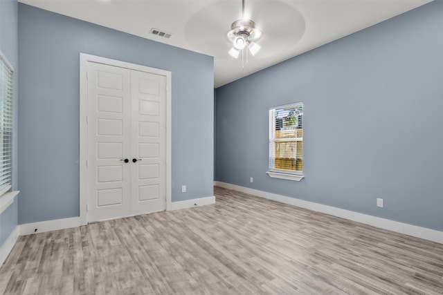 unfurnished bedroom with a closet, ceiling fan, and light hardwood / wood-style floors