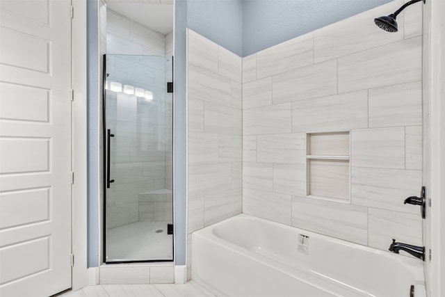 bathroom featuring separate shower and tub