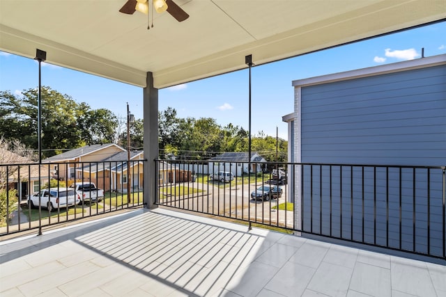 view of patio featuring a balcony and ceiling fan