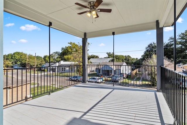 view of patio / terrace with ceiling fan and a balcony