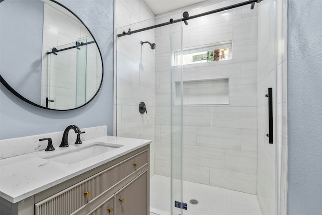 bathroom with vanity and a shower with shower door