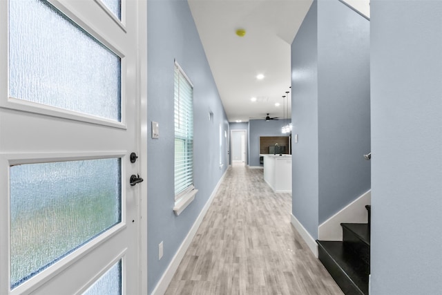 hall featuring a wealth of natural light and light hardwood / wood-style floors