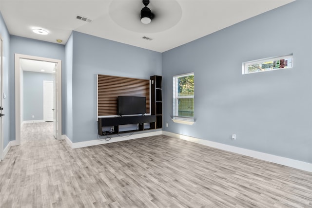 unfurnished living room featuring light hardwood / wood-style flooring and ceiling fan