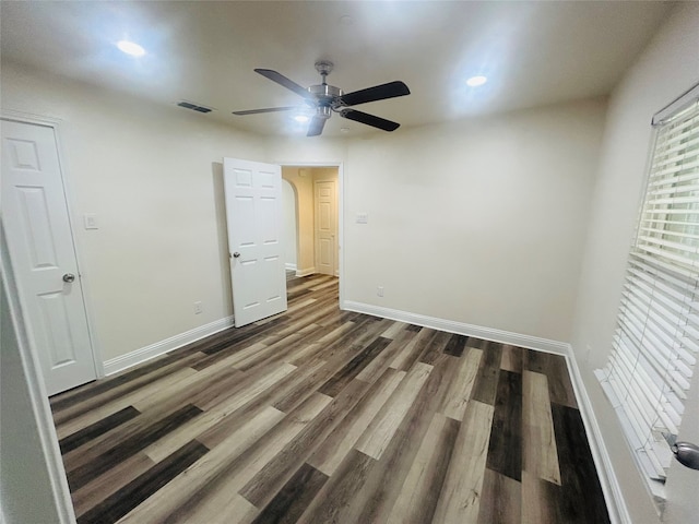 unfurnished room with dark hardwood / wood-style floors and ceiling fan