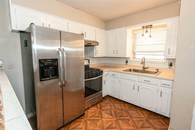 kitchen featuring sink, white cabinetry, decorative backsplash, stainless steel appliances, and dark parquet floors