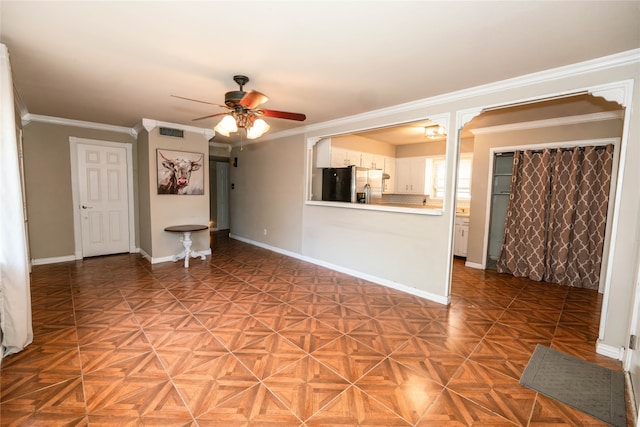 unfurnished living room featuring ornamental molding, parquet flooring, and ceiling fan