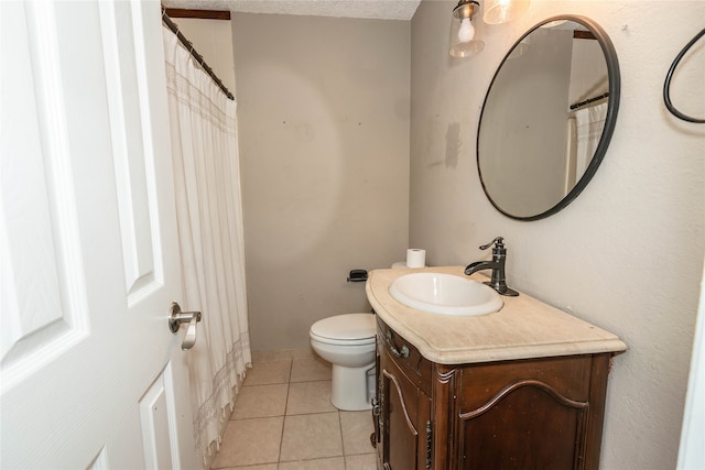 bathroom featuring vanity, tile patterned flooring, toilet, and a textured ceiling