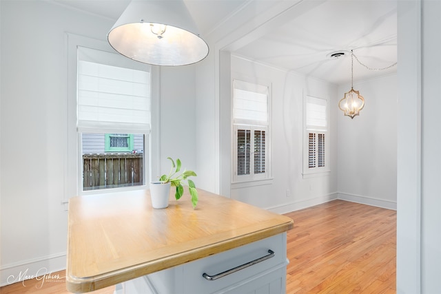 dining space with light wood-type flooring and crown molding