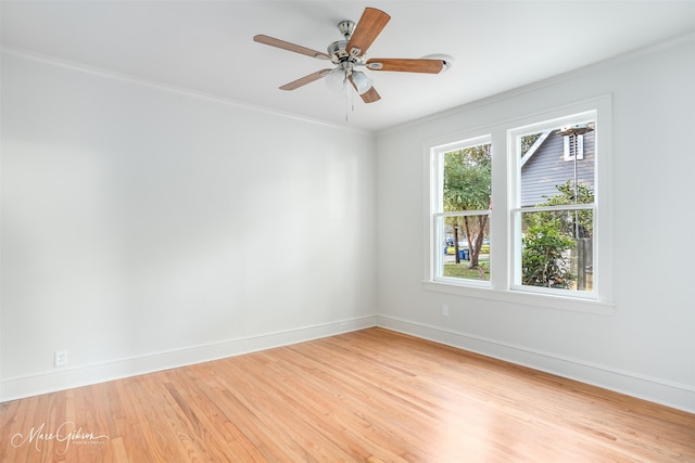 spare room with ornamental molding, light wood-type flooring, and ceiling fan