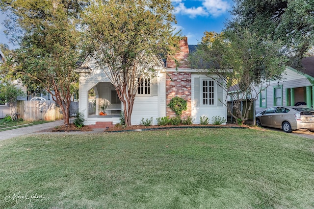 obstructed view of property featuring a front yard