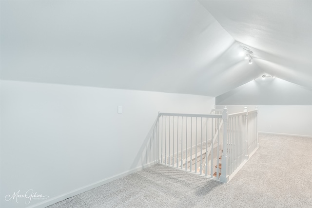 interior space with carpet floors and lofted ceiling