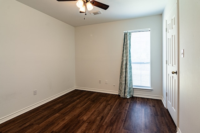 spare room featuring ceiling fan and dark hardwood / wood-style floors