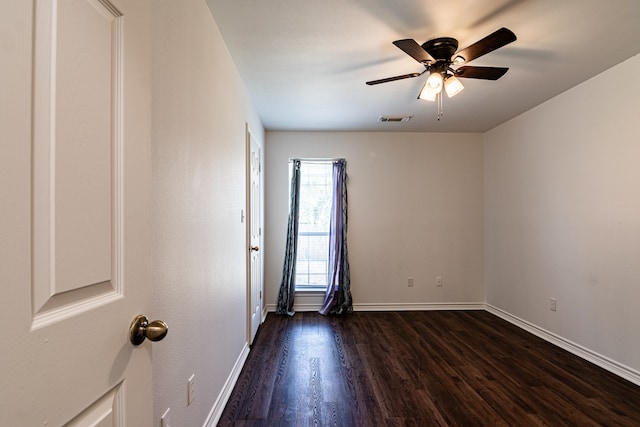 spare room featuring dark hardwood / wood-style floors and ceiling fan