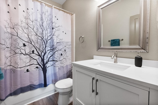 full bathroom featuring wood-type flooring, vanity, toilet, and shower / bathtub combination with curtain