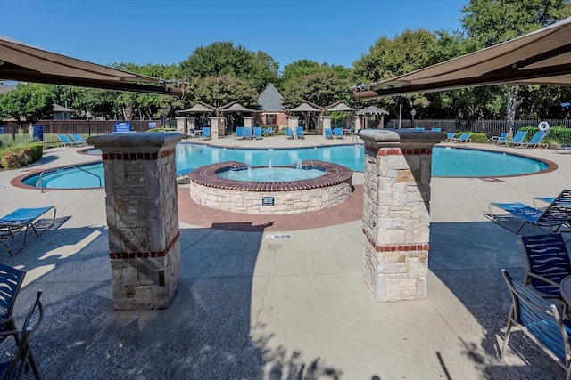 view of pool featuring a patio and a community hot tub