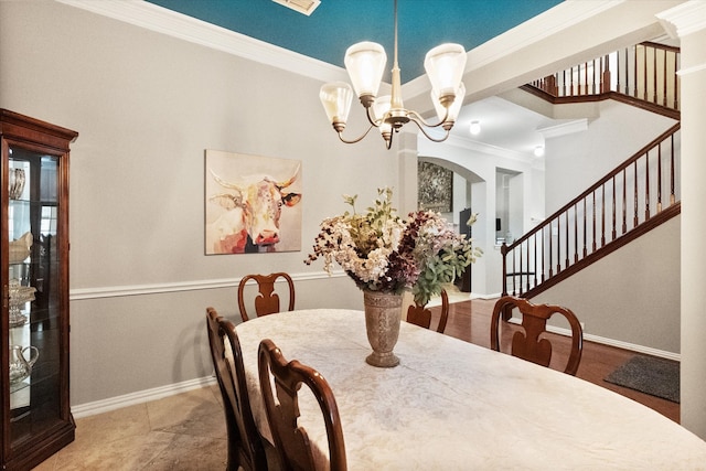 dining space featuring crown molding and a chandelier