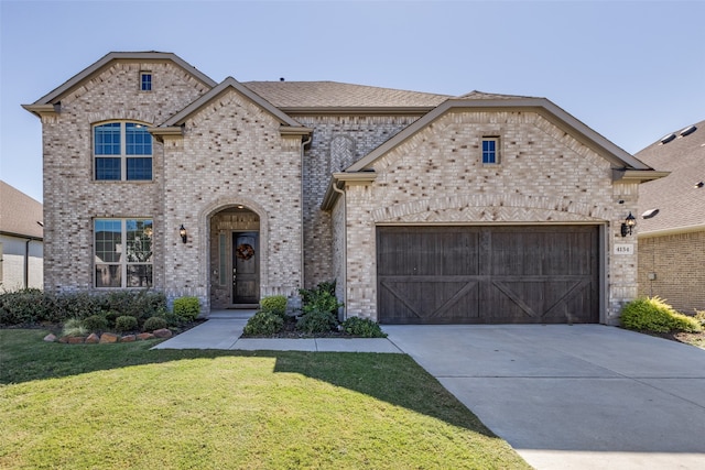 view of front of home featuring a garage and a front yard