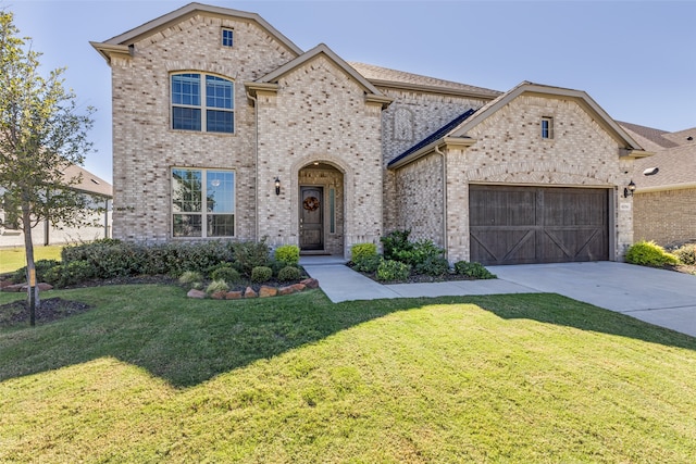 view of front of home with a front lawn and a garage