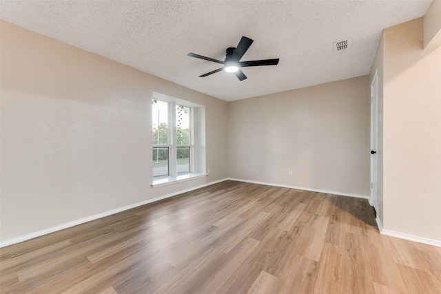 unfurnished room featuring ceiling fan, light hardwood / wood-style flooring, and a textured ceiling