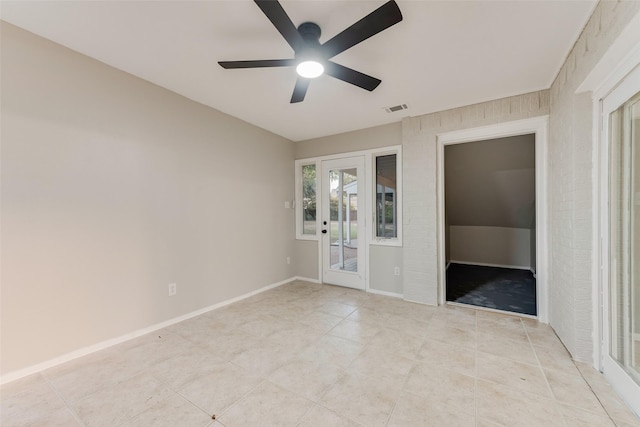 spare room with ceiling fan and french doors