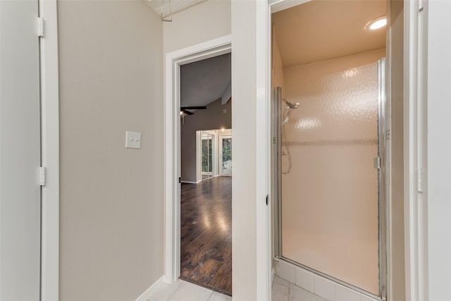 bathroom with hardwood / wood-style floors and an enclosed shower