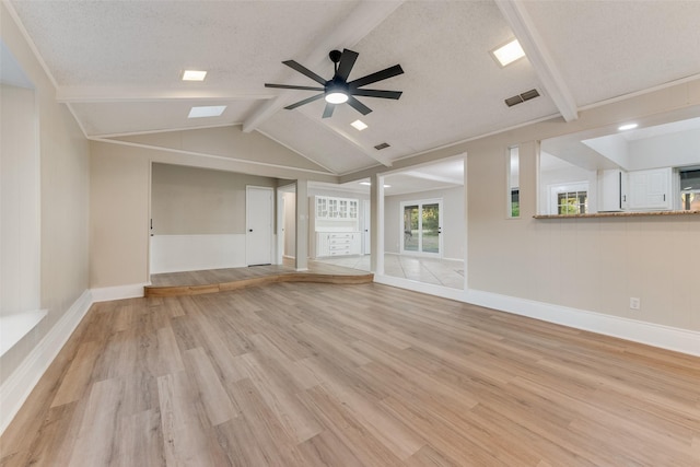 unfurnished living room with vaulted ceiling with beams, a textured ceiling, light hardwood / wood-style floors, and ceiling fan