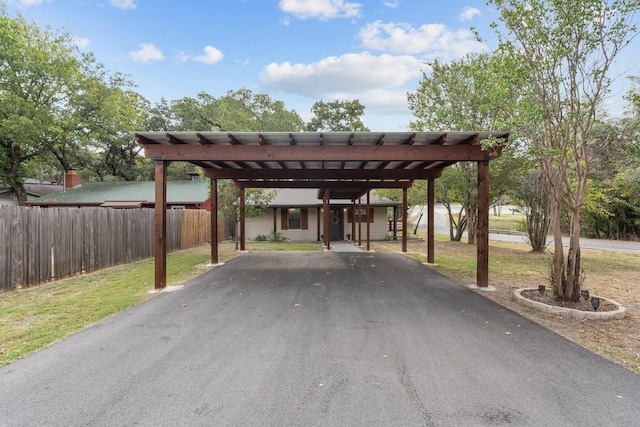 view of parking featuring a carport and a yard