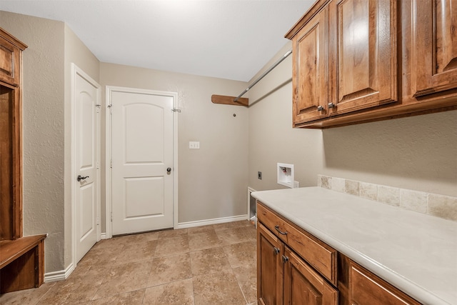 washroom featuring washer hookup, electric dryer hookup, and cabinets