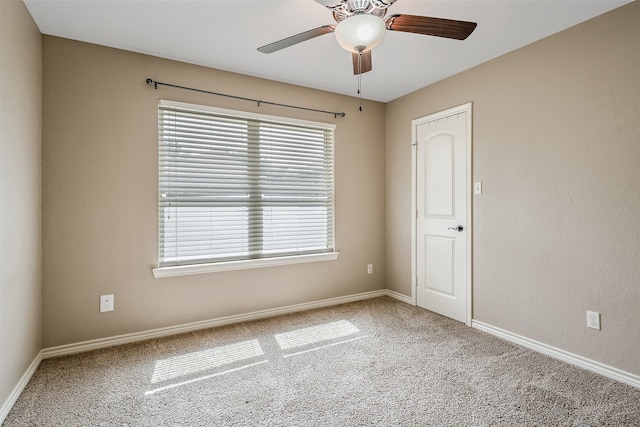 spare room featuring ceiling fan, plenty of natural light, and carpet